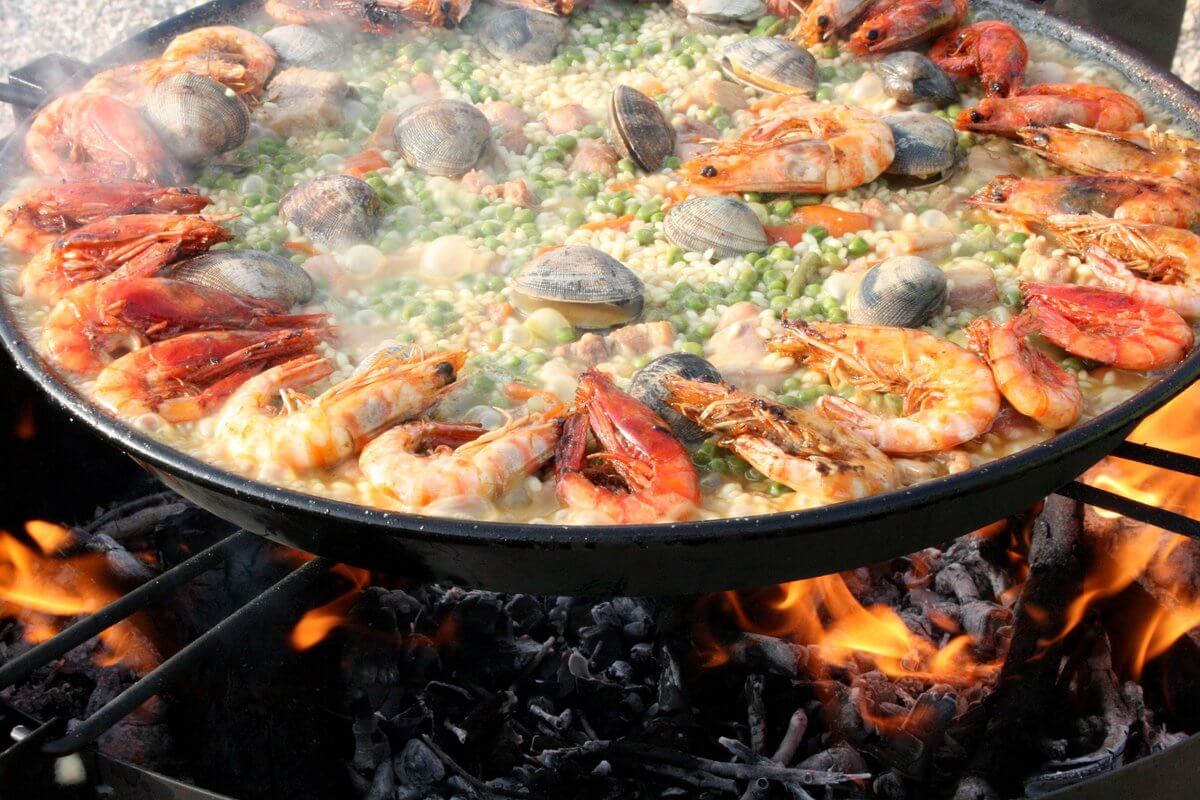 Paella in Barcelona with seafood like mussles, shrimps but also rice, pees. Paella is a traditional food from the south of Spain